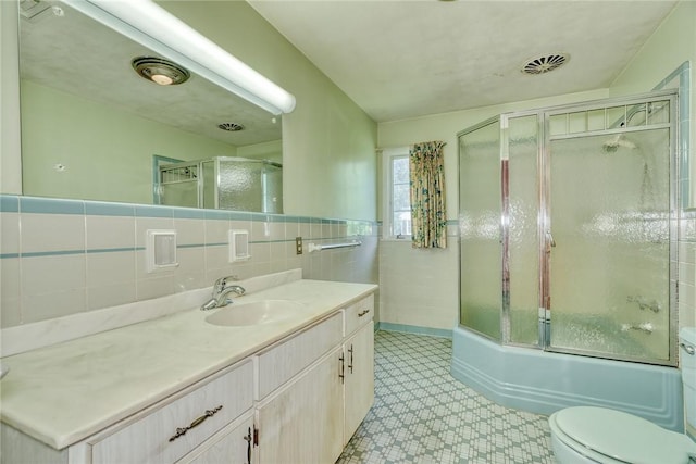 492 Drumm Rd, Webster, NY 14580 - full bathroom with vanity, tile walls, toilet, bath / shower combo with glass door, and tile patterned floors