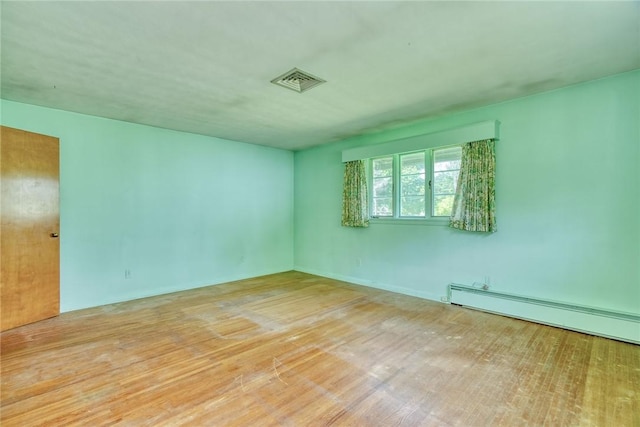 492 Drumm Rd, Webster, NY 14580 - empty room with baseboard heating and wood finished floors