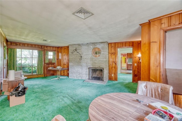 492 Drumm Rd, Webster, NY 14580 - carpeted living room with wood walls and a fireplace