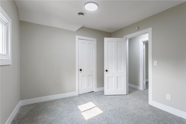 225 Wilder St, Rochester, NY 14611 - unfurnished bedroom featuring carpet, baseboards, and a closet