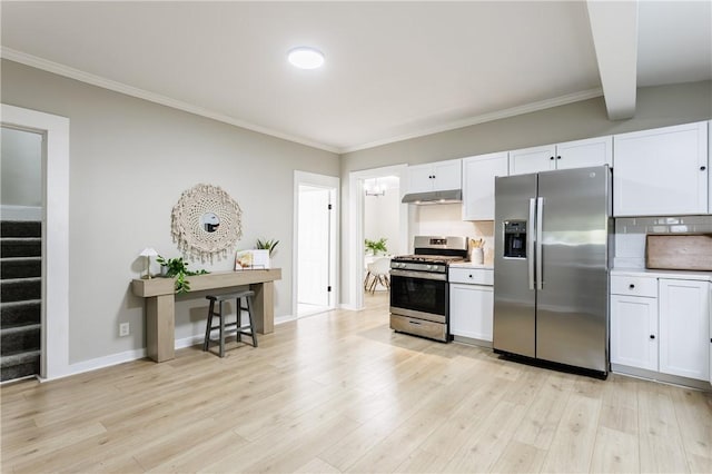 225 Wilder St, Rochester, NY 14611 - kitchen with stainless steel appliances, under cabinet range hood, white cabinets, tasteful backsplash, and light wood-type flooring