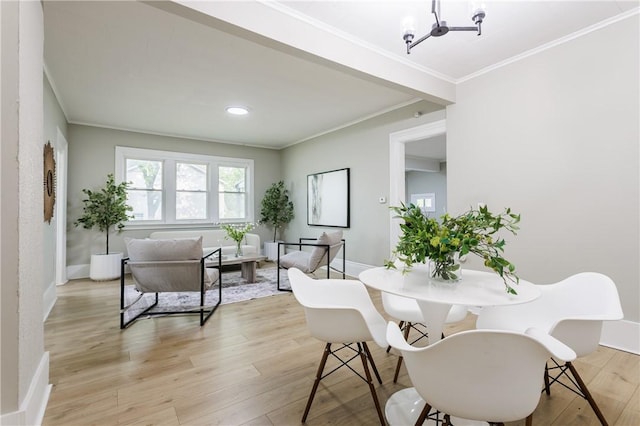 225 Wilder St, Rochester, NY 14611 - dining room with a chandelier, light wood-style flooring, ornamental molding, and baseboards