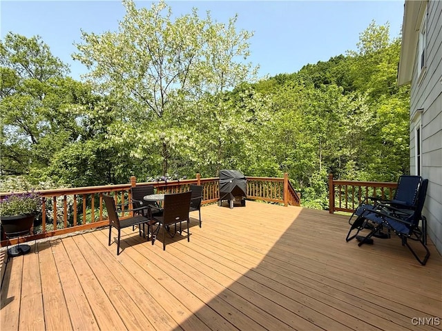 3228 Cedarvale Rd, Onondaga, NY 13120 - wooden deck with outdoor dining area and a grill