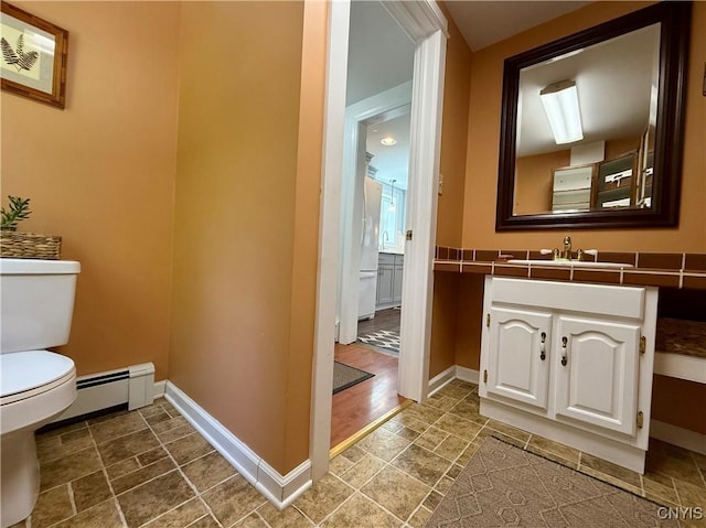 3228 Cedarvale Rd, Onondaga, NY 13120 - bathroom with toilet, baseboards, vanity, and a baseboard heating unit