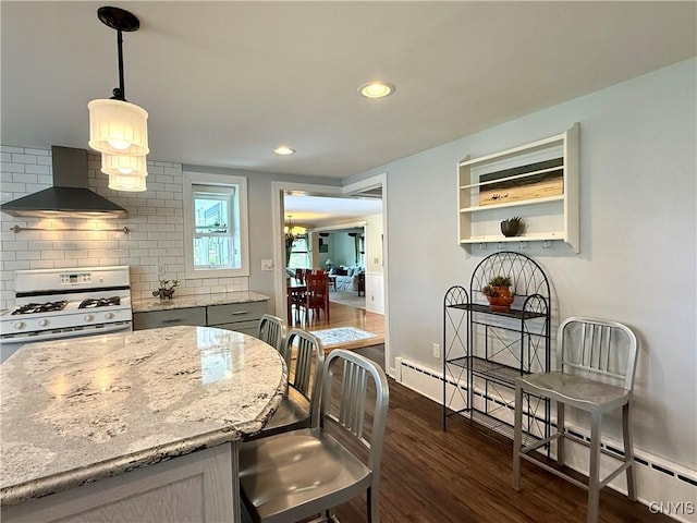 3228 Cedarvale Rd, Onondaga, NY 13120 - kitchen featuring wall chimney exhaust hood, white gas range oven, dark wood-style flooring, backsplash, and light stone counters