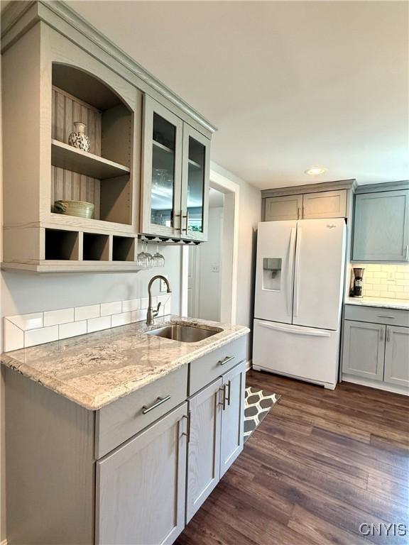 3228 Cedarvale Rd, Onondaga, NY 13120 - kitchen with white refrigerator with ice dispenser, a sink, gray cabinets, and dark wood-type flooring