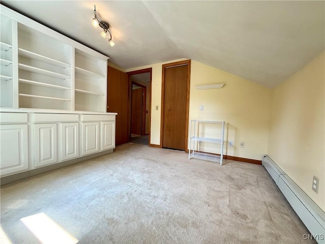3228 Cedarvale Rd, Onondaga, NY 13120 - empty room with a baseboard radiator, light carpet, lofted ceiling, and baseboards