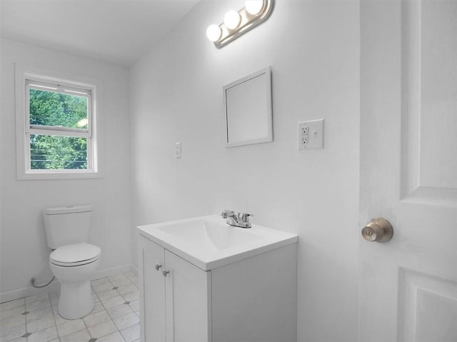 13376 Ridge Rd, Wolcott, NY 14590 - half bath featuring vanity, toilet, baseboards, and tile patterned flooring