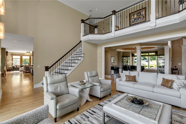 35 Pinegrove Ct, Elma, NY 14059 - living room featuring ornate columns, a high ceiling, light wood finished floors, and plenty of natural light