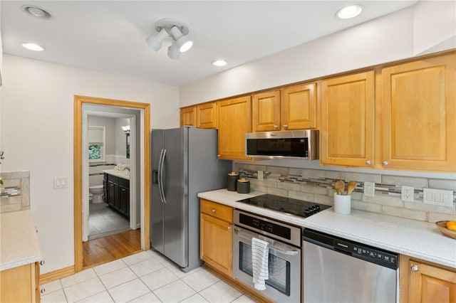 62 E Park Rd, Pittsford, NY 14534 - kitchen featuring stainless steel appliances, light tile patterned floors, light countertops, backsplash, and recessed lighting
