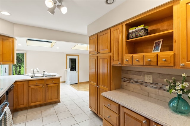 62 E Park Rd, Pittsford, NY 14534 - kitchen featuring a sink, tasteful backsplash, brown cabinetry, light tile patterned floors, and recessed lighting