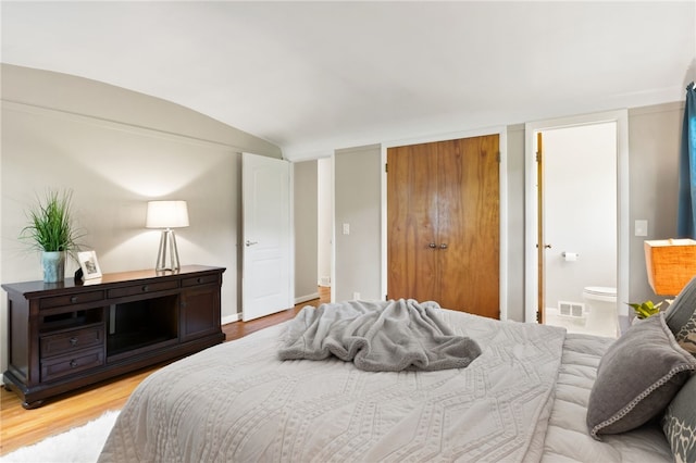 62 E Park Rd, Pittsford, NY 14534 - bedroom featuring light wood-type flooring, vaulted ceiling, ensuite bathroom, a closet, and baseboards