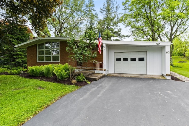 62 E Park Rd, Pittsford, NY 14534 - view of front of home with a front lawn, asphalt driveway, and brick siding