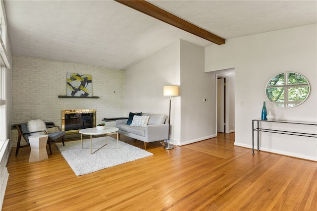 62 E Park Rd, Pittsford, NY 14534 - living room with light wood-style floors, a brick fireplace, and baseboards