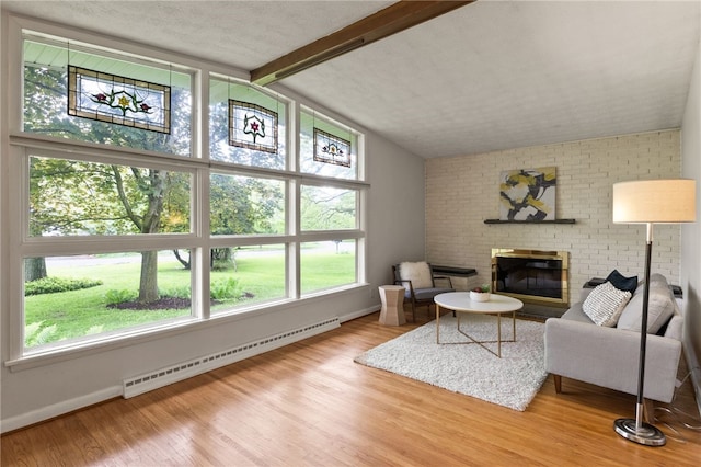 62 E Park Rd, Pittsford, NY 14534 - living area with a baseboard heating unit, a fireplace, plenty of natural light, and wood finished floors