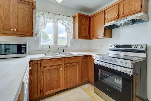 16 Hazel Bark Run, Gates, NY 14606 - kitchen featuring appliances with stainless steel finishes, under cabinet range hood, a sink, and brown cabinetry