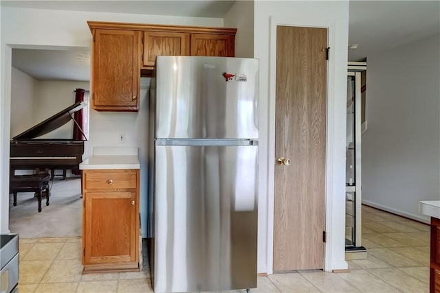 16 Hazel Bark Run, Gates, NY 14606 - kitchen featuring freestanding refrigerator, brown cabinets, and light countertops