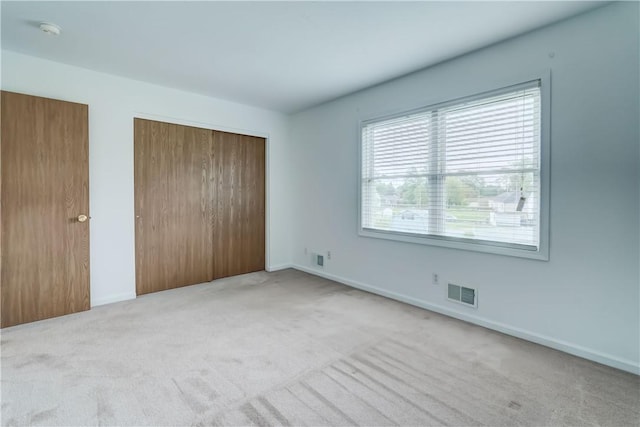 16 Hazel Bark Run, Gates, NY 14606 - unfurnished bedroom with a closet, carpet, and baseboards