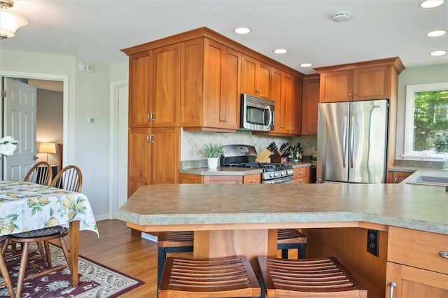 1485 S Lake Rd, Middlesex, NY 14507 - kitchen featuring stainless steel appliances, decorative backsplash, recessed lighting, light countertops, and light wood-type flooring