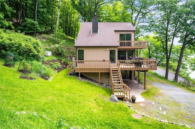 1485 S Lake Rd, Middlesex, NY 14507 - rear view of property featuring stairway, dirt driveway, a wooden deck, a chimney, and roof with shingles