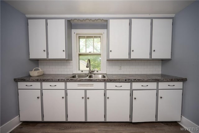 5557 Seneca St, West Seneca, NY 14224 - kitchen featuring a sink, baseboards, decorative backsplash, and dark wood-style flooring