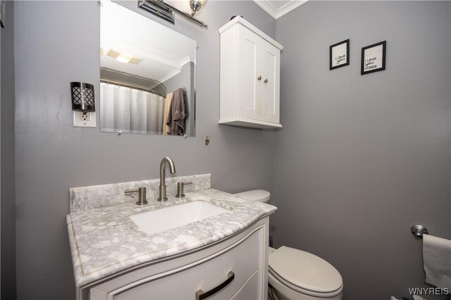 5557 Seneca St, West Seneca, NY 14224 - bathroom with ornamental molding, toilet, and vanity