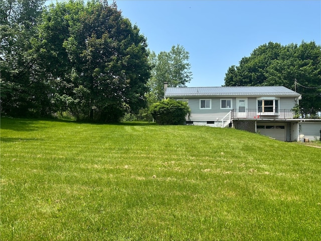 516 County Road 26, Phelps, NY 14513 - back of property featuring a wooden deck, an attached garage, a yard, metal roof, and stairway