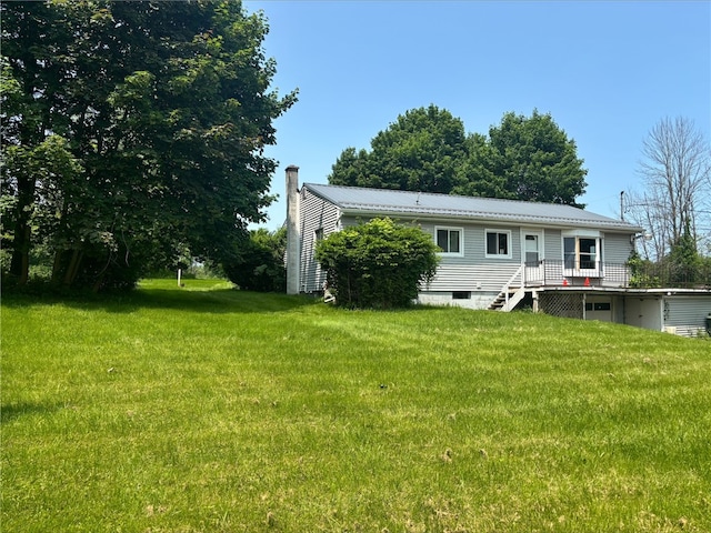 516 County Road 26, Phelps, NY 14513 - back of property featuring a chimney, a yard, and metal roof