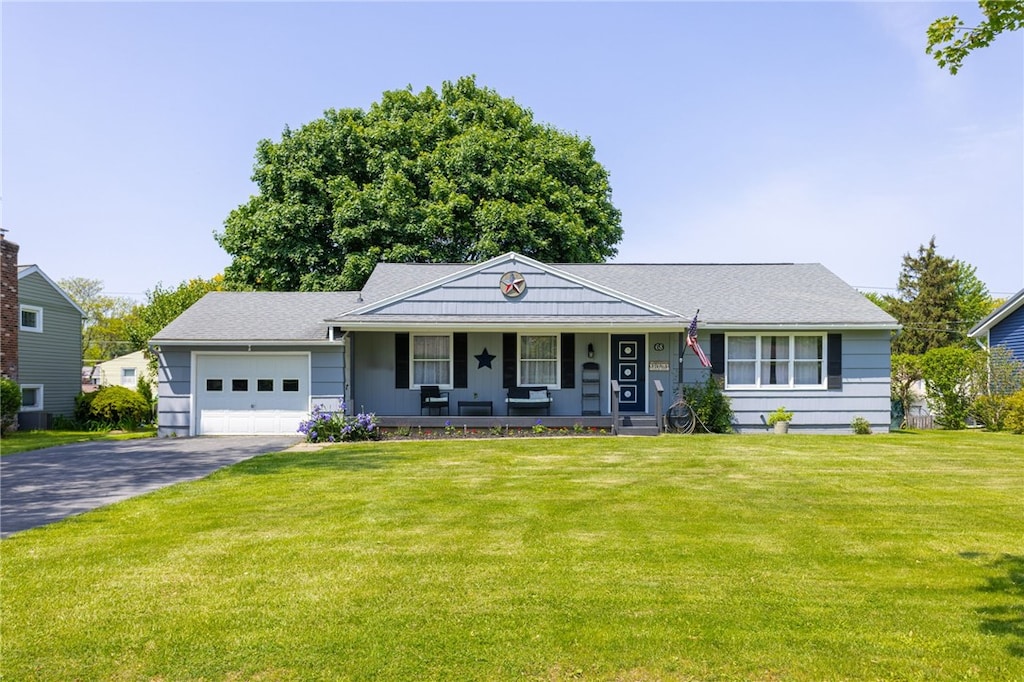 68 Little Tree Ln, Parma, NY 14468 - single story home with a porch, driveway, an attached garage, and a front lawn