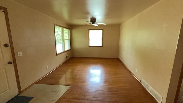153 Carlisle St, Greece, NY 14615 - spare room with a ceiling fan, light wood-type flooring, and baseboards