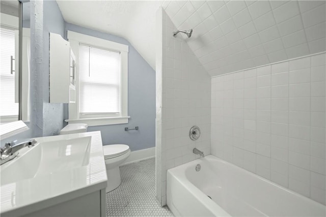 37 Ernestine St, Rochester, NY 14619 - bathroom with lofted ceiling, vanity, toilet, tile patterned floors, and bathtub / shower combination