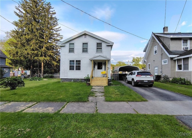 233 Elm St, German Flatts, NY 13357 - traditional-style home with a detached carport, a front yard, and driveway