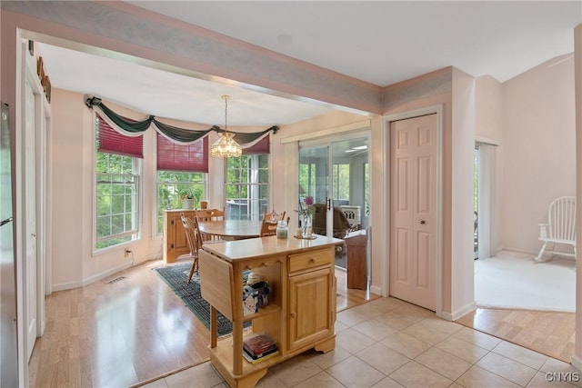 112 Ausable Run, Salina, NY 13088 - kitchen with a chandelier, light countertops, light wood finished floors, baseboards, and a center island