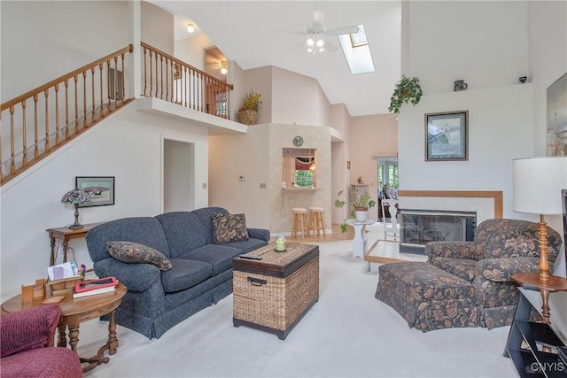 112 Ausable Run, Salina, NY 13088 - living area with high vaulted ceiling, carpet flooring, stairs, a skylight, and a ceiling fan