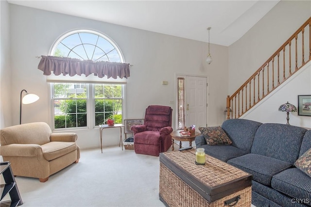 112 Ausable Run, Salina, NY 13088 - living area featuring carpet floors, stairway, and a towering ceiling