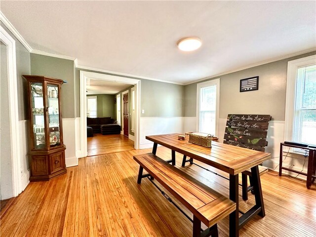 7573 State Route 21, Naples, NY 14512 - dining space featuring light wood-style flooring, ornamental molding, and wainscoting
