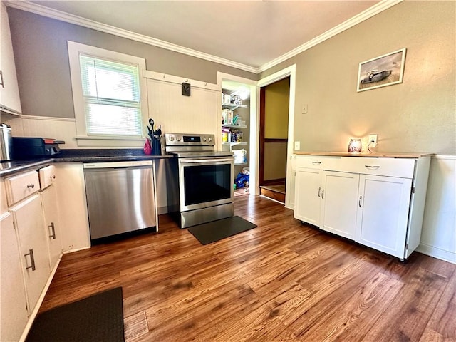 7573 State Route 21, Naples, NY 14512 - kitchen featuring appliances with stainless steel finishes, ornamental molding, dark wood-style floors, white cabinetry, and dark countertops