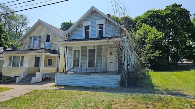 198 Mulberry St, Buffalo, NY 14204 - view of front of property featuring a porch, a balcony, a front lawn, and a chimney