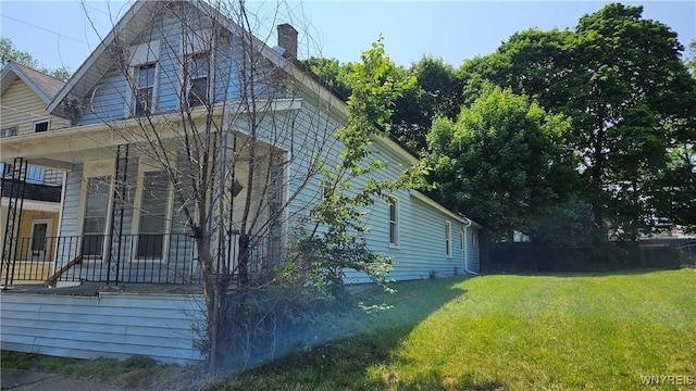 198 Mulberry St, Buffalo, NY 14204 - view of side of home featuring a chimney and a yard