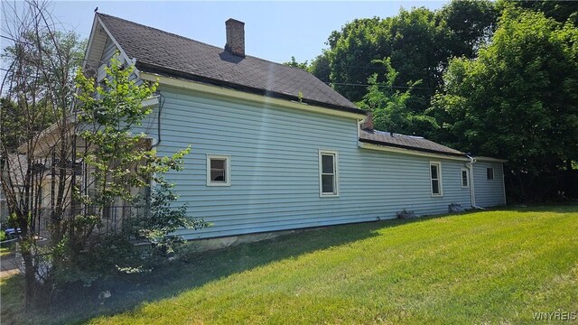 198 Mulberry St, Buffalo, NY 14204 - view of side of home featuring a chimney, a yard, and roof with shingles