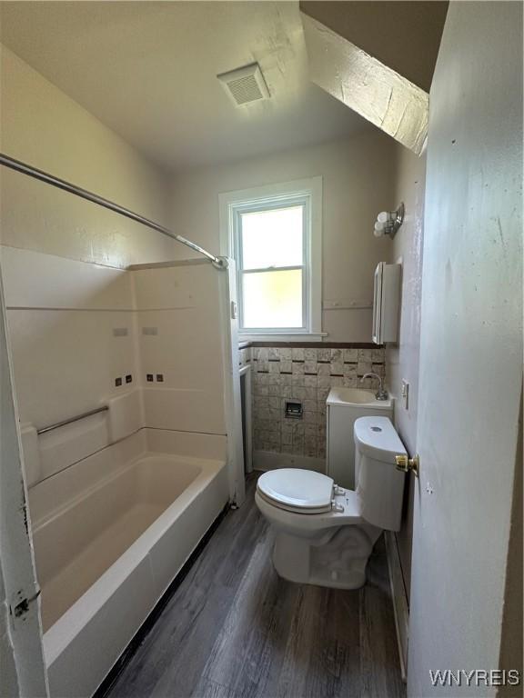325 Rhode Island St, Buffalo, NY 14213 - bathroom featuring toilet, wood finished floors, shower / washtub combination, and tile walls