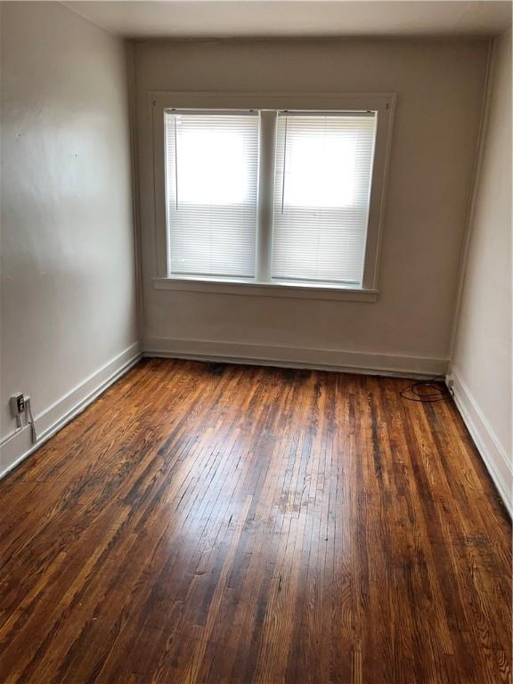 571 Lake Ave, Rochester, NY 14613 - empty room featuring wood-type flooring and baseboards