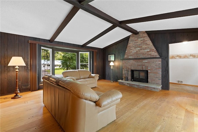 136 Cranbrooke Dr, Irondequoit, NY 14622 - living room with wooden walls, light wood-style flooring, and a fireplace