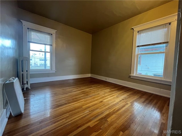 11 Cleveburn Pl Unit 1, Buffalo, NY 14222 - spare room featuring dark wood-style flooring and baseboards