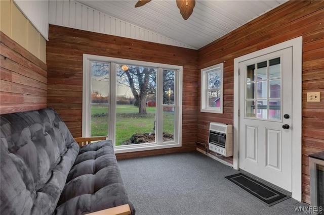 3293 Hartland Rd, Hartland, NY 14067 - doorway featuring heating unit, vaulted ceiling, wood walls, carpet flooring, and ceiling fan
