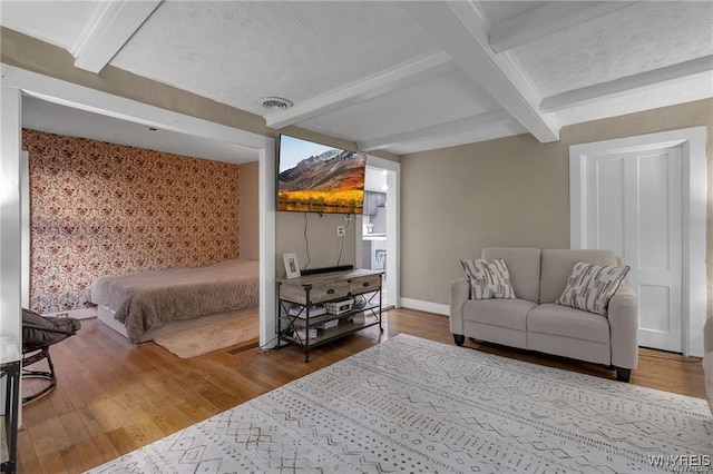 3293 Hartland Rd, Hartland, NY 14067 - bedroom featuring beam ceiling, wood finished floors, baseboards, and wallpapered walls