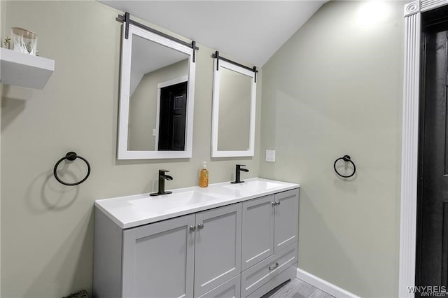 3293 Hartland Rd, Hartland, NY 14067 - full bath with vaulted ceiling, double vanity, baseboards, and wood finished floors