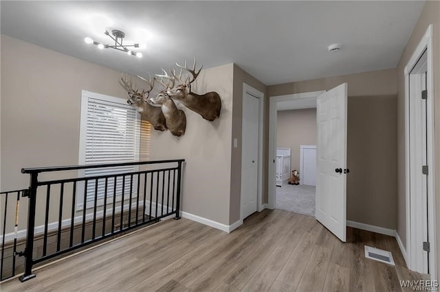 3293 Hartland Rd, Hartland, NY 14067 - unfurnished dining area with wood finished floors, baseboards, and a chandelier
