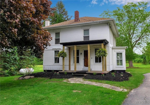 3293 Hartland Rd, Hartland, NY 14067 - traditional style home with a chimney, a porch, and a front yard