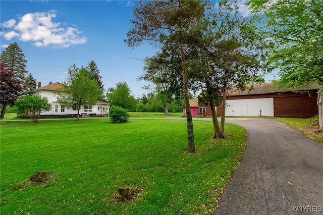 3293 Hartland Rd, Hartland, NY 14067 - view of green lawn featuring asphalt driveway